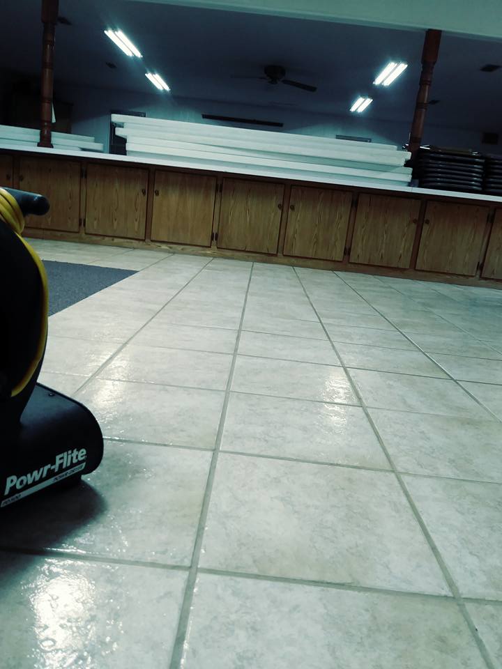 A gym with tile floors and a mirror