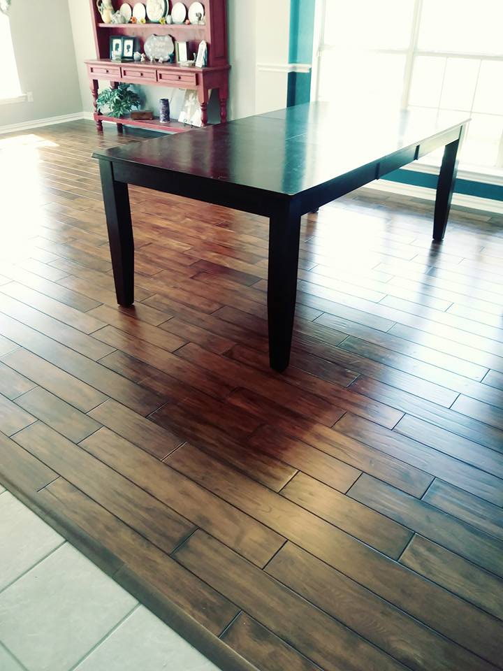 A wooden table sitting on top of a hard wood floor.