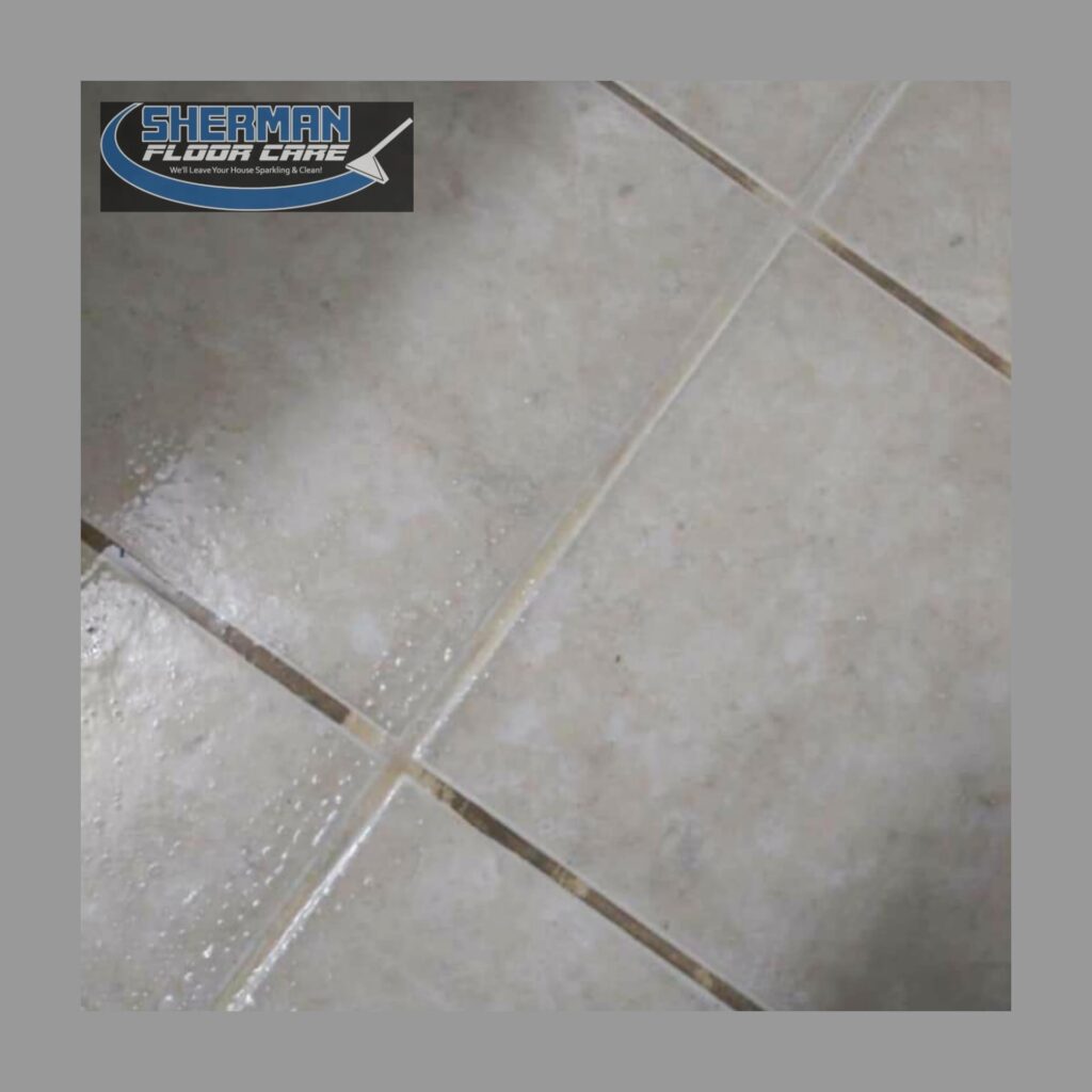 A tile floor with white grout and blue logo.