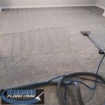 A carpet cleaning machine is being used to clean the floor.
