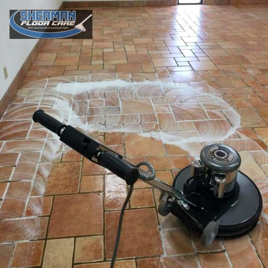 A floor cleaning machine is spraying water on the tile.