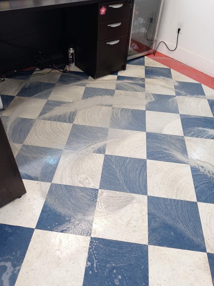 A blue and white checkered floor with a black cabinet