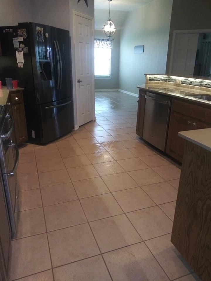 A kitchen with tile floors and stainless steel appliances.