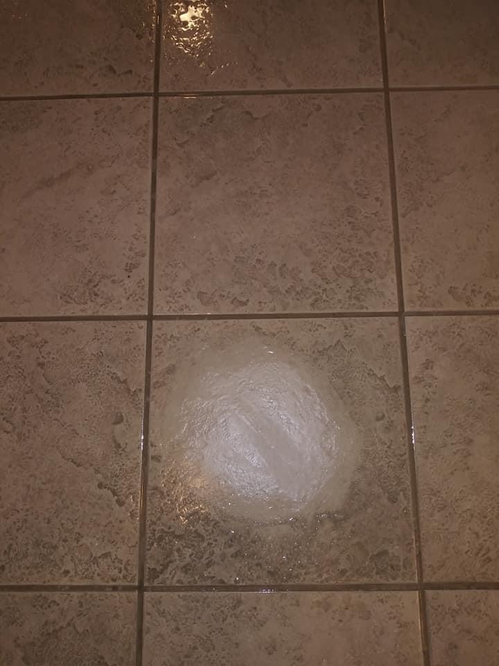 A tile floor with a light on it