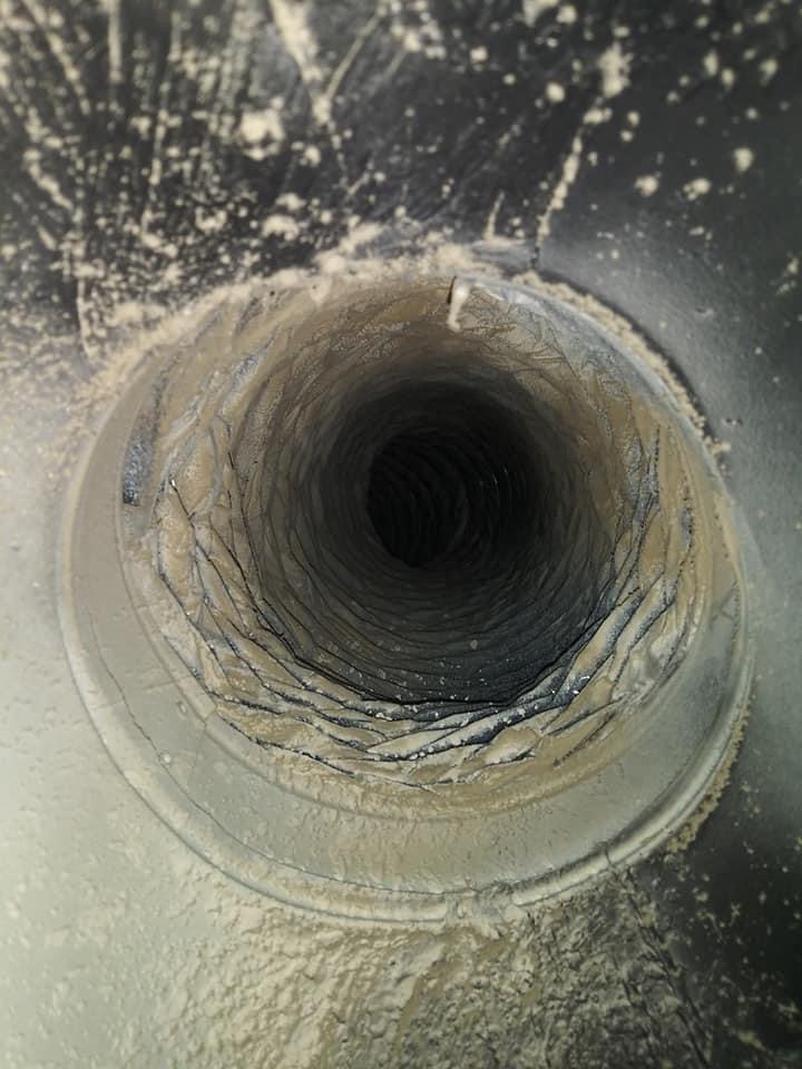 A view of the inside of a pipe with water coming out.