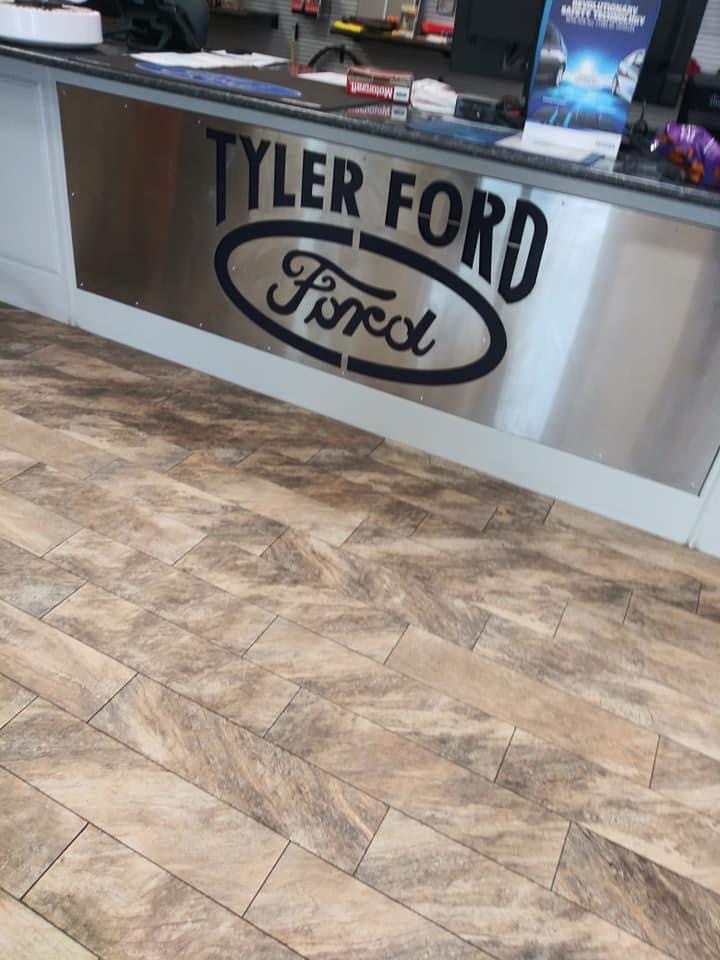 A floor with a sign on it that says tyler ford.