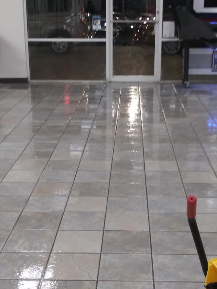 A tile floor with a red object in the middle of it.