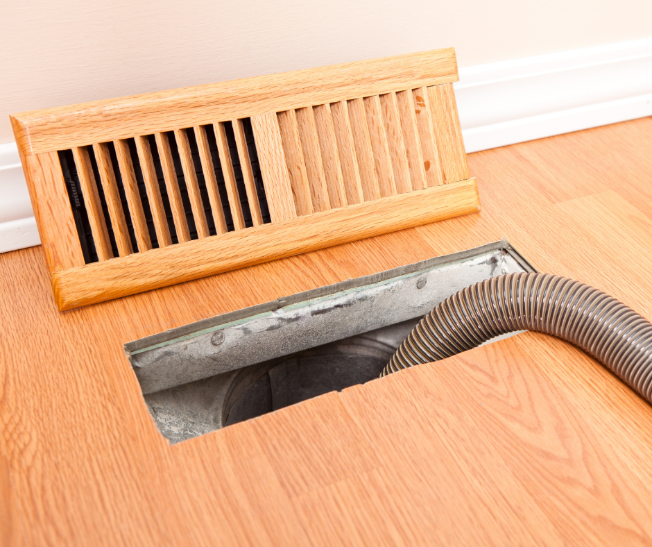 A vent and duct on the floor of a house.